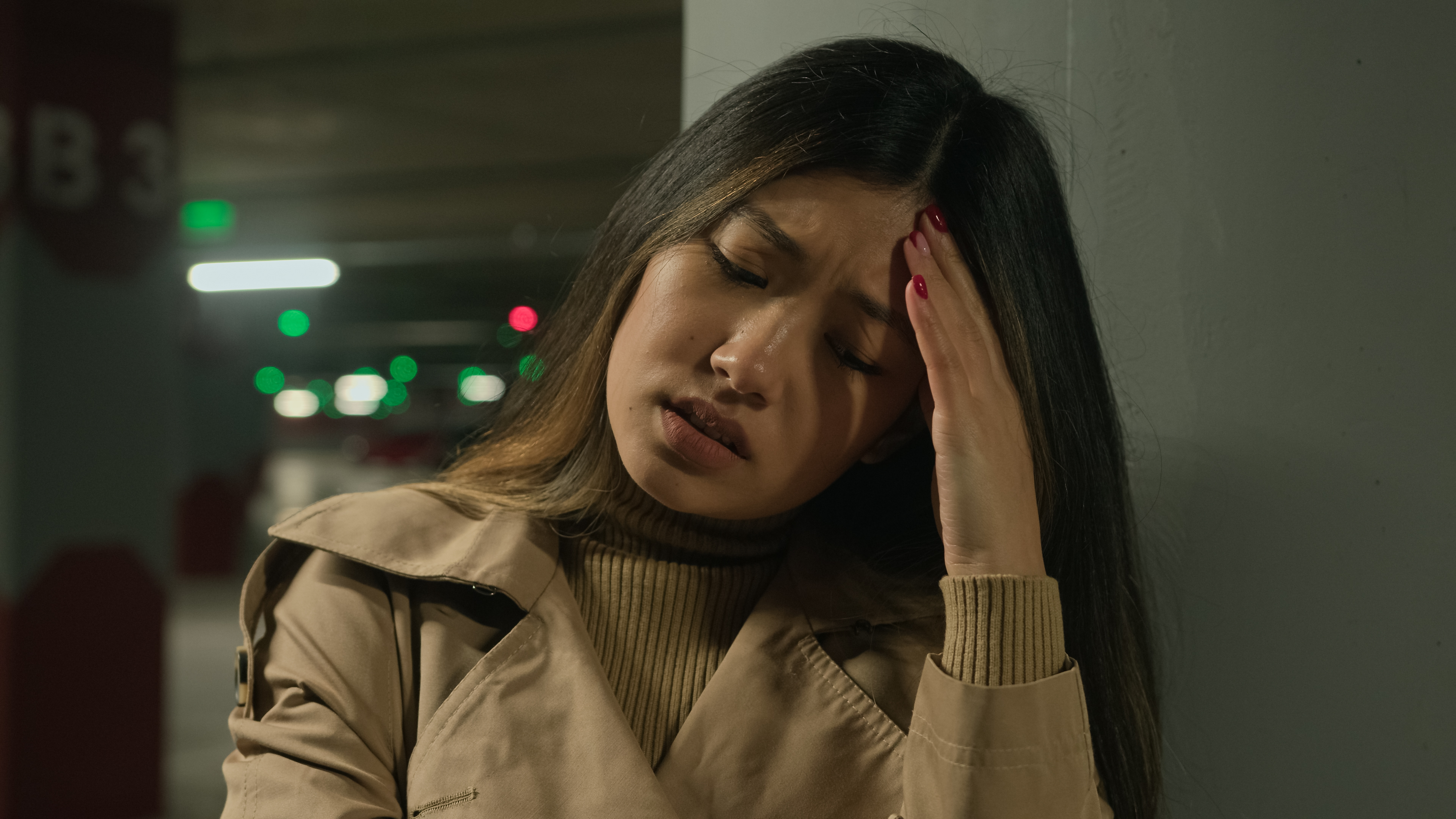 Sick Asian woman suffer headache in parking painful head migraine ache health problem high blood pressure ethnic korean chinese japanese girl feel bad covid symptom unwell illness stress discomfort. High quality 4k footage